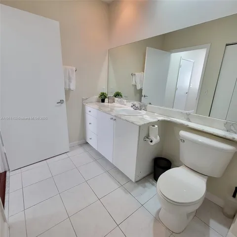 a bathroom with a sink a toilet and mirror
