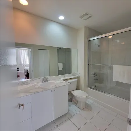 a bathroom with a double vanity sink toilet and shower