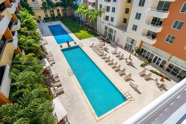 a view of swimming pool with lounge chair and potted plants