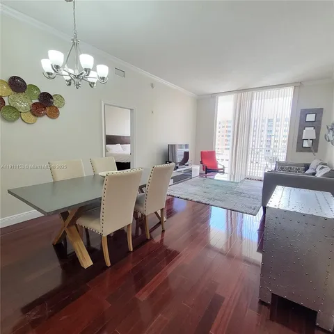 a living room with furniture dining table a lamp and a window