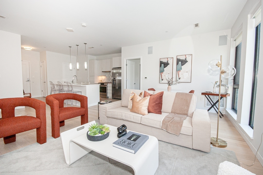 45 West 3rd Street, Unit 409 Boston, MA 02127 - Photo 1 of 30 a living room with furniture and a table
