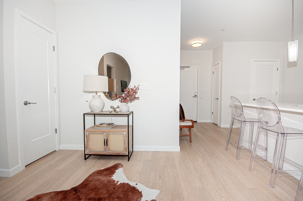 45 West 3rd Street, Unit 409 Boston, MA 02127 - Photo 13 of 30 a living room with furniture and a wooden floor