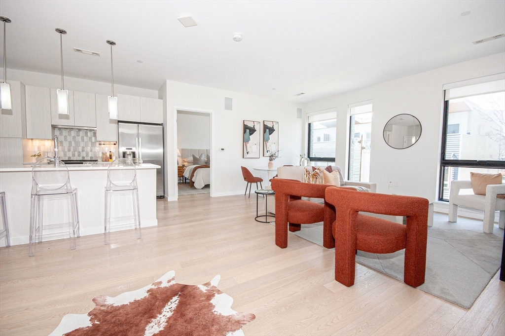 45 West 3rd Street, Unit 409 Boston, MA 02127 - Photo 14 of 30 a living room with furniture a clock and a window