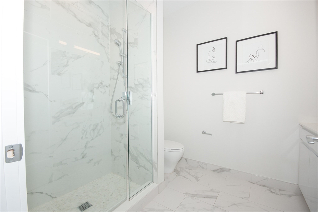 45 West 3rd Street, Unit 409 Boston, MA 02127 - Photo 17 of 30 a bathroom with a toilet and shower