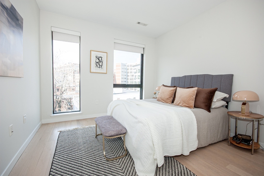 45 West 3rd Street, Unit 409 Boston, MA 02127 - Photo 18 of 30 a bedroom with a bed and a window