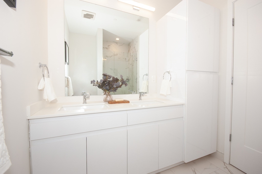 45 West 3rd Street, Unit 409 Boston, MA 02127 - Photo 19 of 30 a bathroom with a sink and a mirror