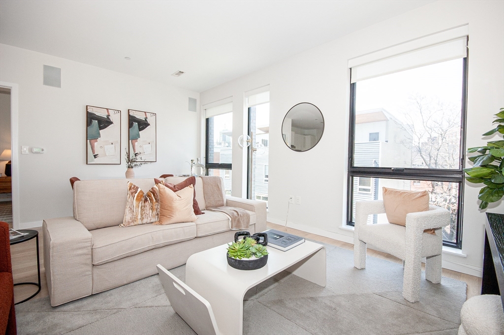 45 West 3rd Street, Unit 409 Boston, MA 02127 - Photo 2 of 30 a living room with furniture and a window