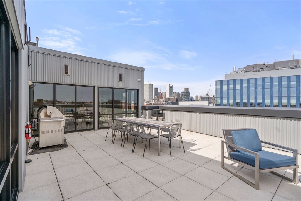 45 West 3rd Street, Unit 409 Boston, MA 02127 - Photo 22 of 30 a view of roof deck with table and chairs and potted plants