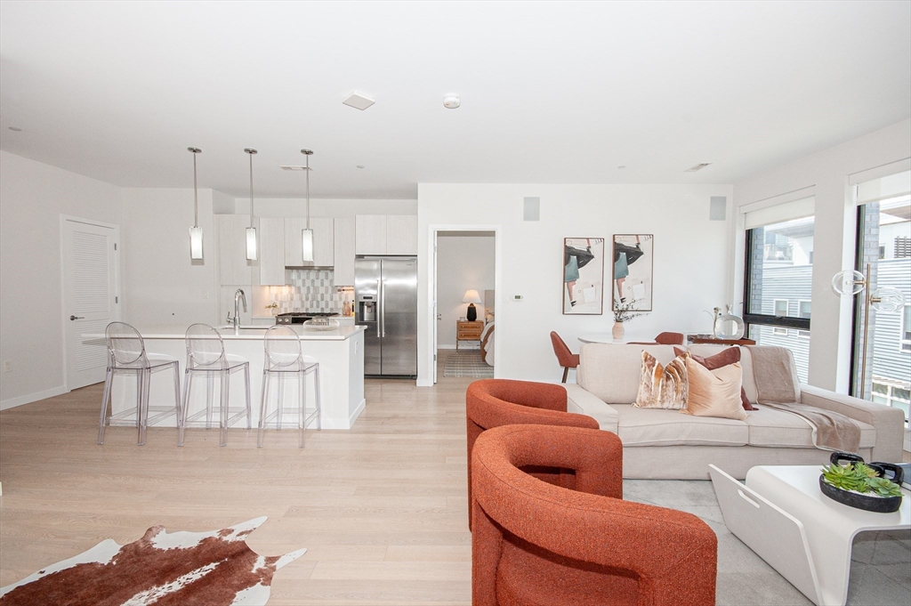 45 West 3rd Street, Unit 409 Boston, MA 02127 - Photo 4 of 30 a living room with furniture and a large window