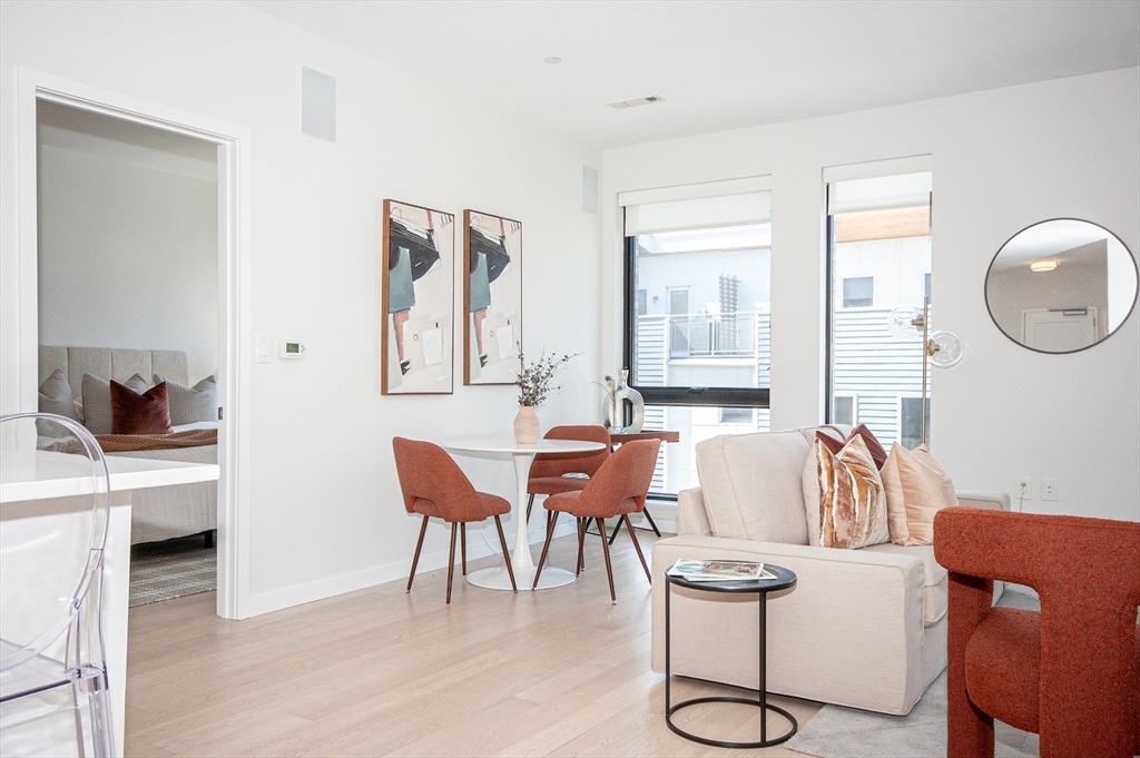 45 West 3rd Street, Unit 409 Boston, MA 02127 - Photo 6 of 30 a living room with furniture and a table