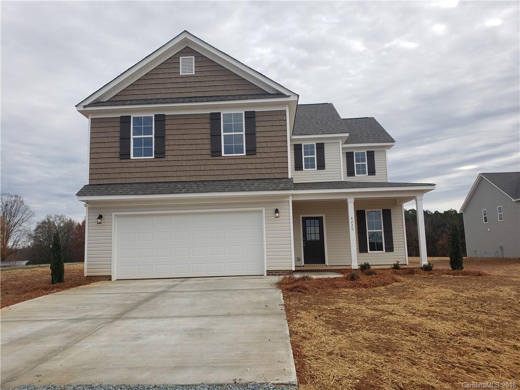 4220 Sincerity Road, Unit 4 Monroe, NC 28110 - Photo 1 of 23 a front view of a house with a yard and garage