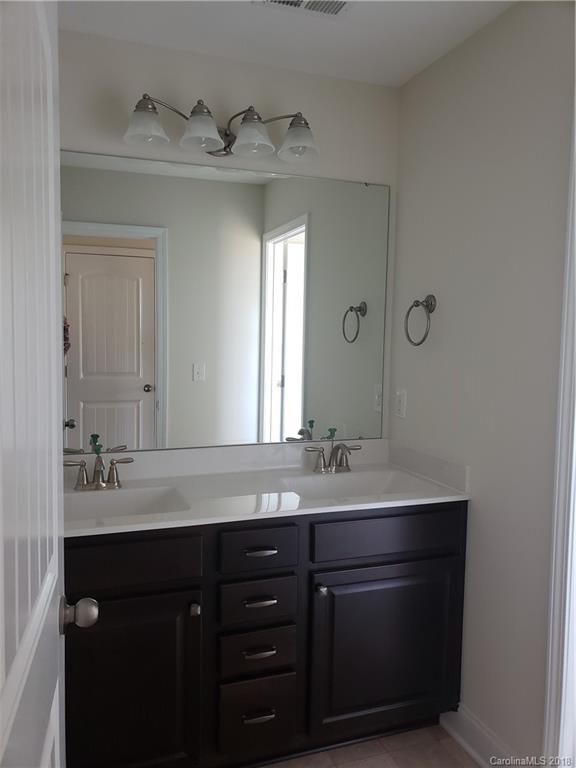 4220 Sincerity Road, Unit 4 Monroe, NC 28110 - Photo 11 of 23 a bathroom with a sink vanity and mirror