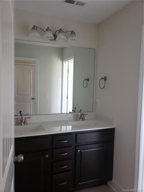 4220 Sincerity Road, Unit 4 Monroe, NC 28110 - Photo 12 of 23 a bathroom with a double vanity sink and mirror