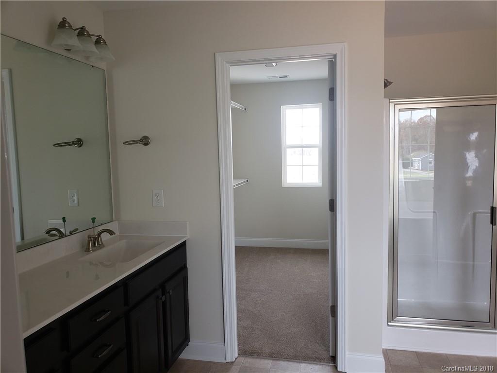 4220 Sincerity Road, Unit 4 Monroe, NC 28110 - Photo 16 of 23 a bathroom with a double vanity sink a mirror and a shower