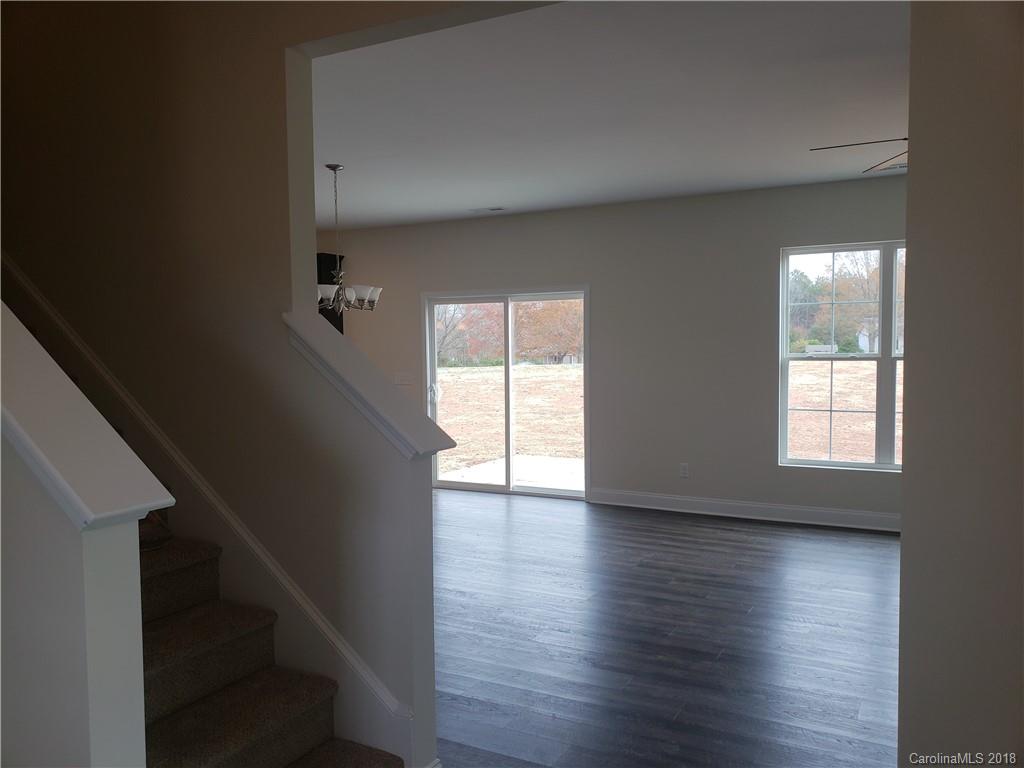 4220 Sincerity Road, Unit 4 Monroe, NC 28110 - Photo 21 of 23 a view of an empty room with wooden floor and a window