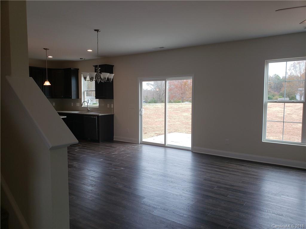 4220 Sincerity Road, Unit 4 Monroe, NC 28110 - Photo 22 of 23 an empty room with wooden floor and windows