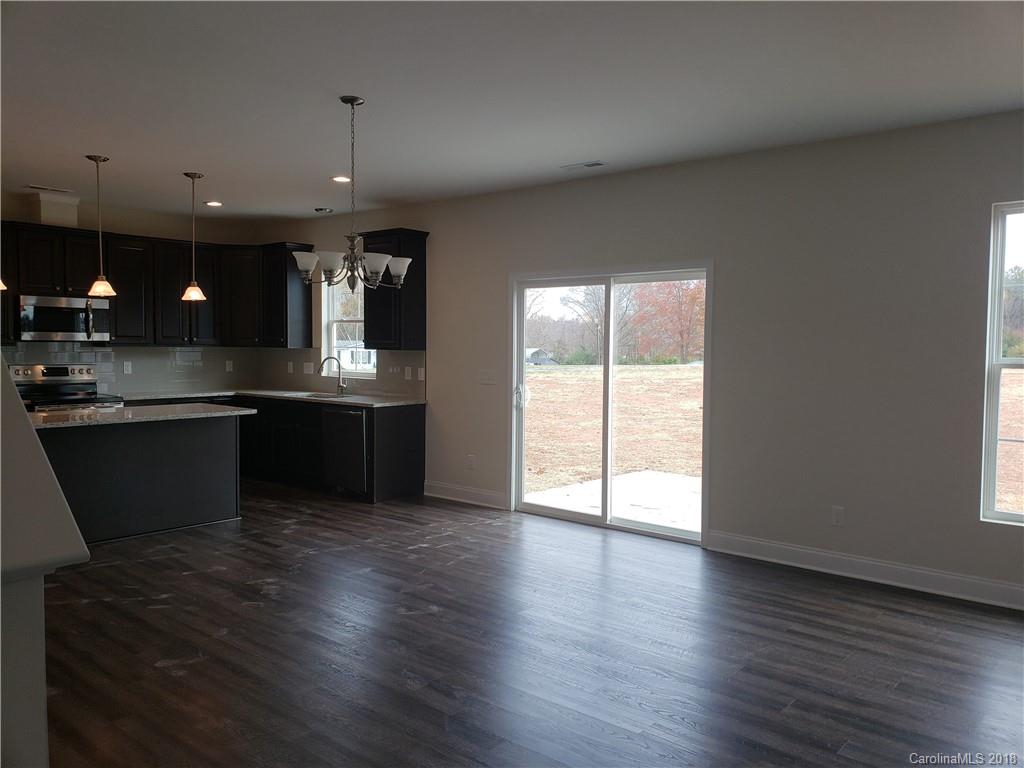 4220 Sincerity Road, Unit 4 Monroe, NC 28110 - Photo 23 of 23 an open kitchen with wooden floor and a sink