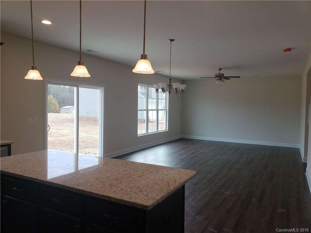 4220 Sincerity Road, Unit 4 Monroe, NC 28110 - Photo 5 of 23 a kitchen with a sink chandelier and wooden floor