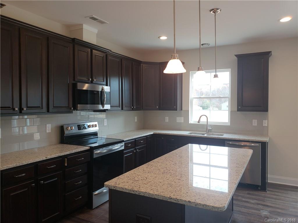 4220 Sincerity Road, Unit 4 Monroe, NC 28110 - Photo 6 of 23 a kitchen with stainless steel appliances granite countertop a sink a microwave a stove and a refrigerator