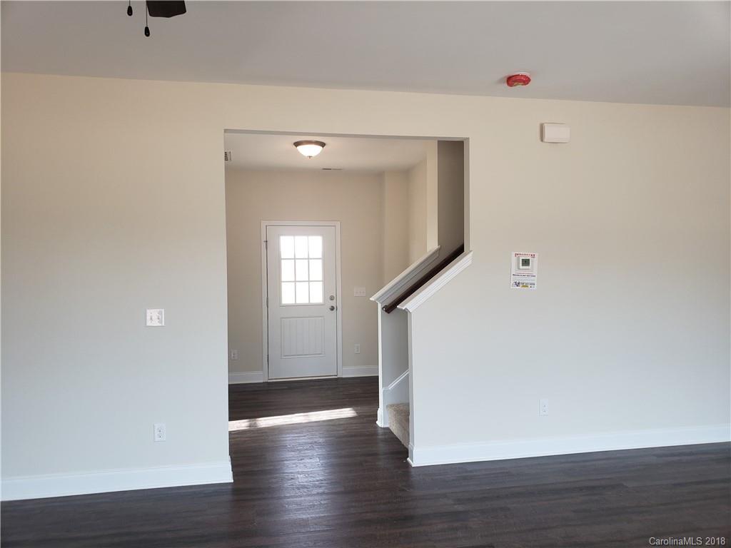 4220 Sincerity Road, Unit 4 Monroe, NC 28110 - Photo 7 of 23 a view of empty room with wooden floor and fan