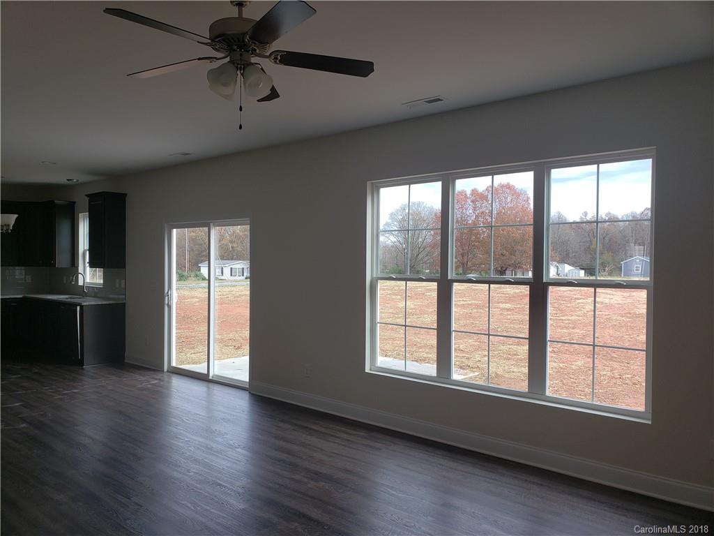 4220 Sincerity Road, Unit 4 Monroe, NC 28110 - Photo 8 of 23 a view of an empty room with a window and wooden floor