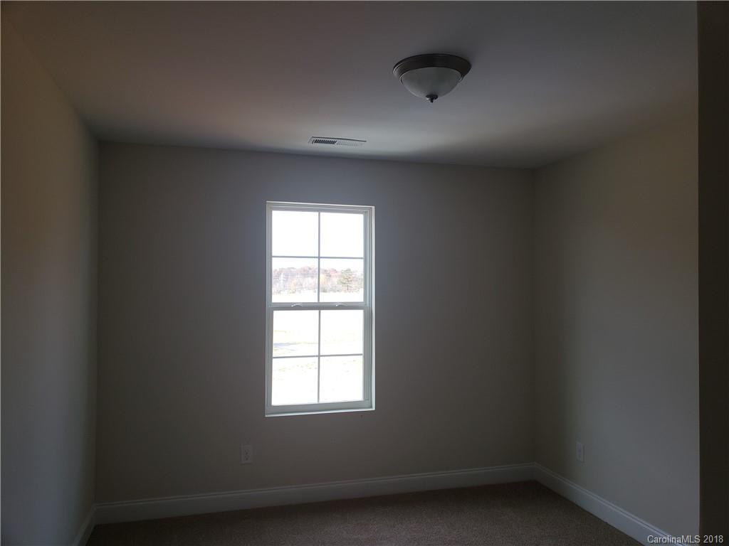 4220 Sincerity Road, Unit 4 Monroe, NC 28110 - Photo 10 of 23 an empty room with a window
