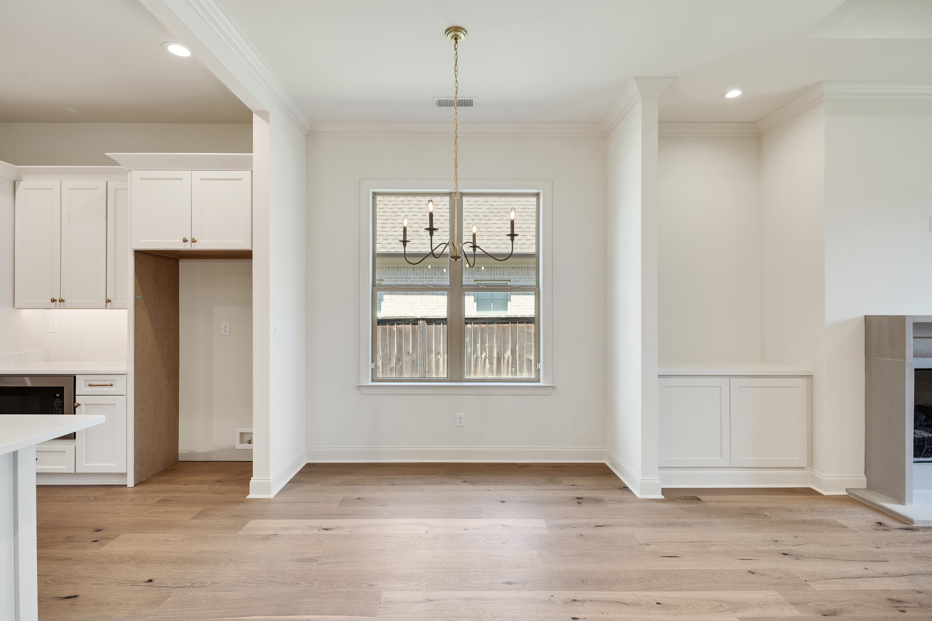 3406 Village Cross Loop Collierville, TN 38017 - Photo 11 of 40 Wood-finish flooring, recessed lighting, built-in cabinetry, and a window with a chandelier fixture