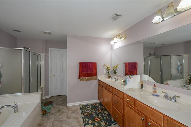 172 Villa Pl Court Tucker, GA 30084 - Photo 15 of 18 a spacious bathroom with a double vanity sink mirror and shower