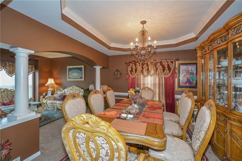 172 Villa Pl Court Tucker, GA 30084 - Photo 6 of 18 a living room with patio furniture and a chandelier