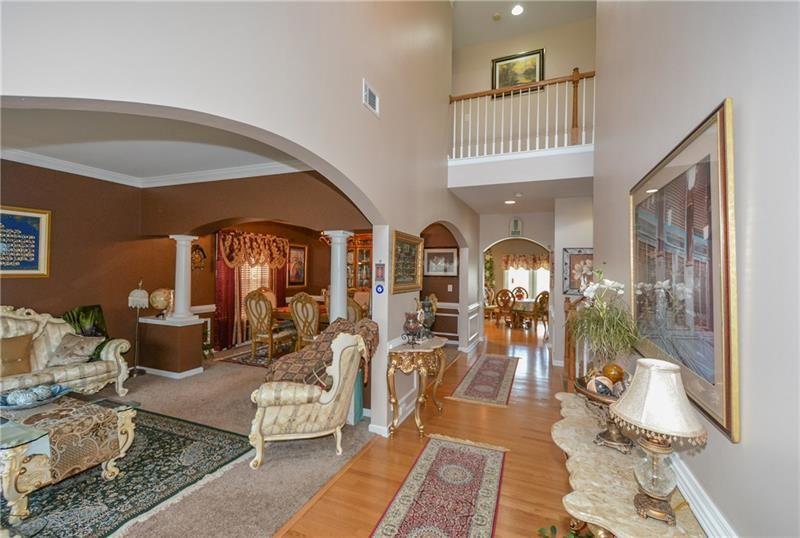 172 Villa Pl Court Tucker, GA 30084 - Photo 8 of 18 a living room with furniture a chandelier and glass door