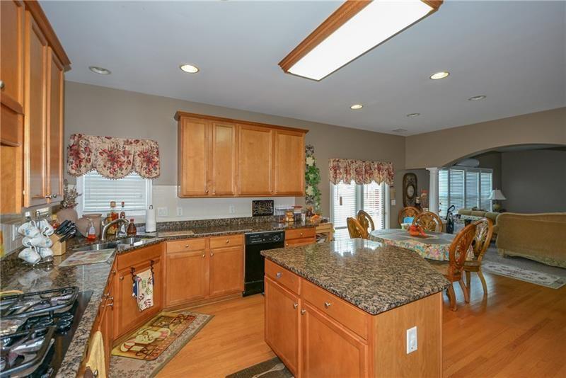 172 Villa Pl Court Tucker, GA 30084 - Photo 10 of 18 a kitchen with granite countertop kitchen island stainless steel appliances a sink stove and table