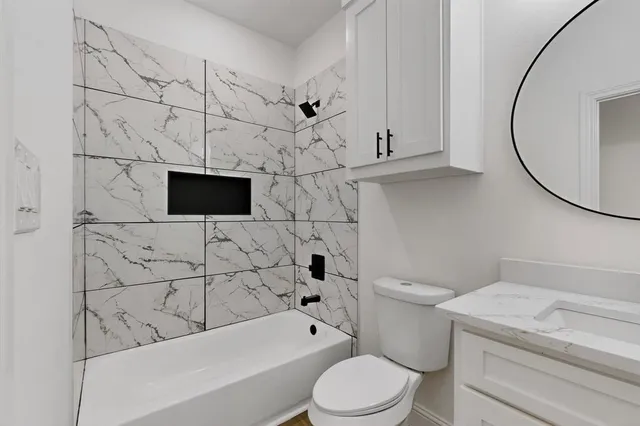 a bathroom with a sink a toilet and bathtub