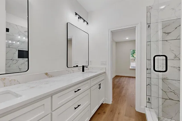 a bathroom with a double vanity sink and mirror