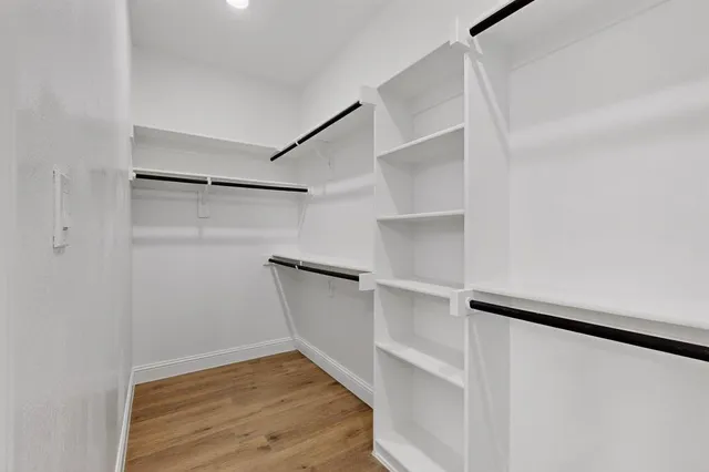 a view of walk in closet with empty racks