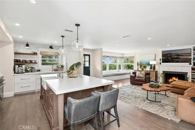 a living room with fireplace furniture and a wooden floor
