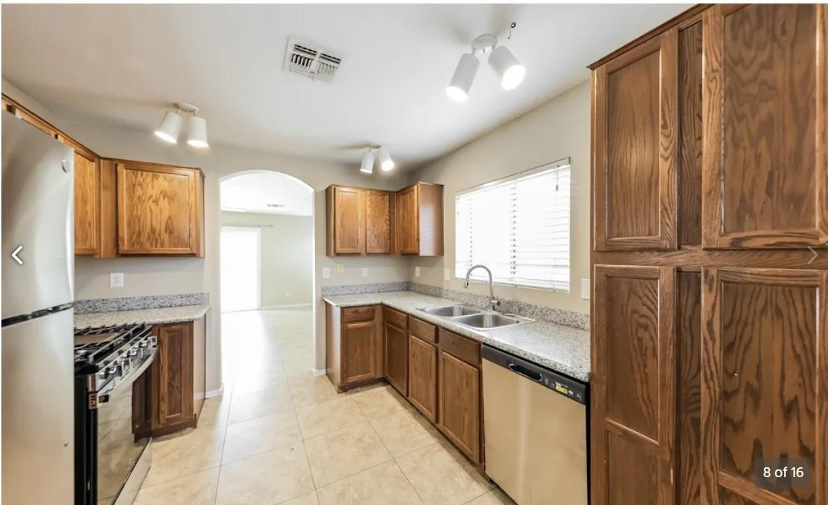 12563 West Charter Oak Road El Mirage, AZ 85335 - Photo 8 of 16 a kitchen with stainless steel appliances granite countertop a sink a stove and a refrigerator