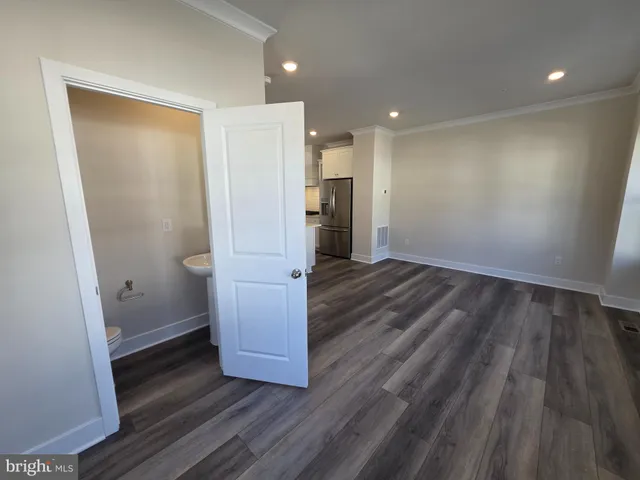 a kitchen with stainless steel appliances a refrigerator and a stove top oven