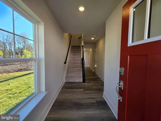a view of entryway and hall with wooden floor