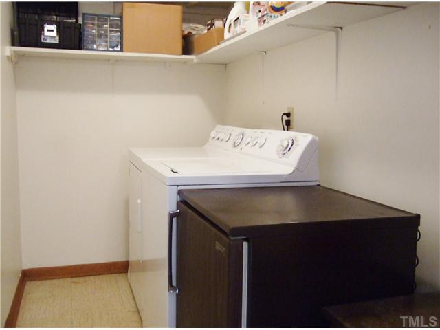 4225 Redington Drive Raleigh, NC 27609 - Photo 20 of 25 A separate laundry room with shelves, is large enough to accommodate not only the washer/dryer, but also a small frig. Laundry Room