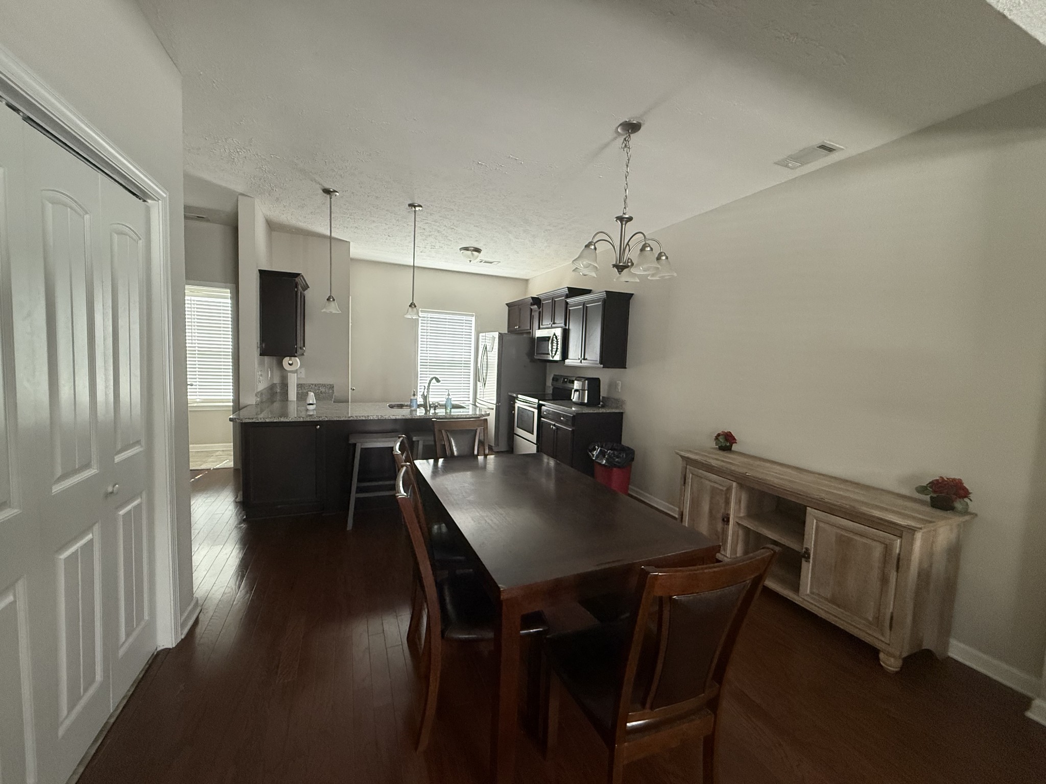 146 Ramsden Avenue La Vergne, TN 37086 - Photo 4 of 11 a view of a dining room and livingroom with furniture wooden floor a chandelier