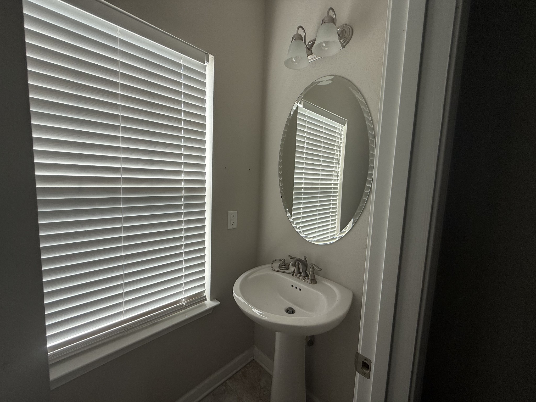 146 Ramsden Avenue La Vergne, TN 37086 - Photo 5 of 11 a bathroom with a sink a mirror and a window
