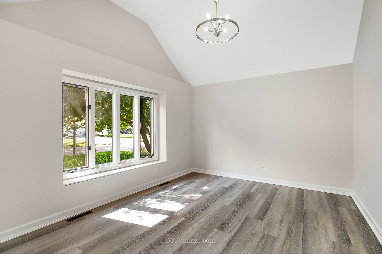 32 Robert Road Oswego, IL 60543 - Photo 3 of 33 an empty room with wooden floor and windows