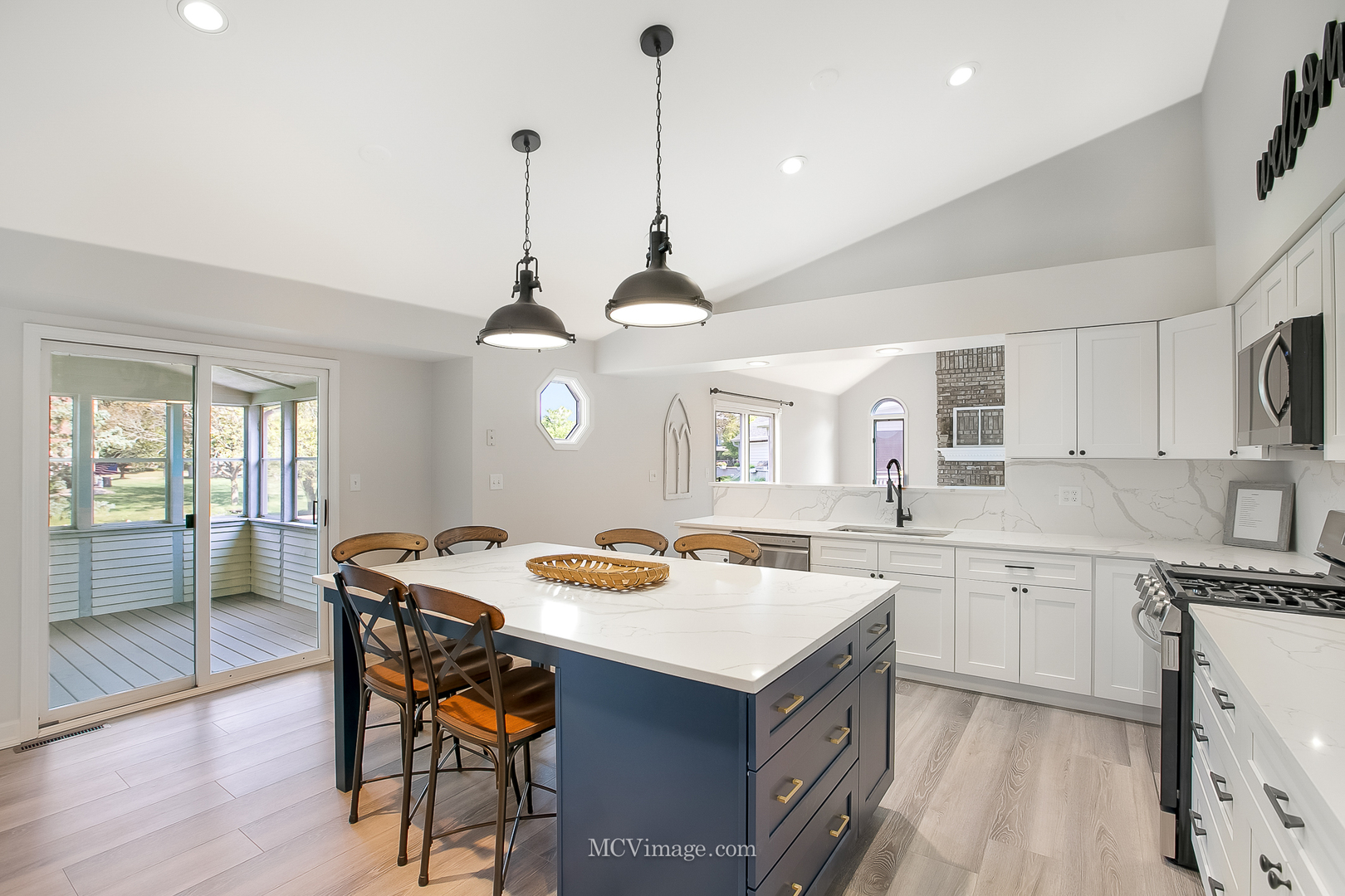 32 Robert Road Oswego, IL 60543 - Photo 5 of 33 a kitchen with a stove a sink a dining table and chairs