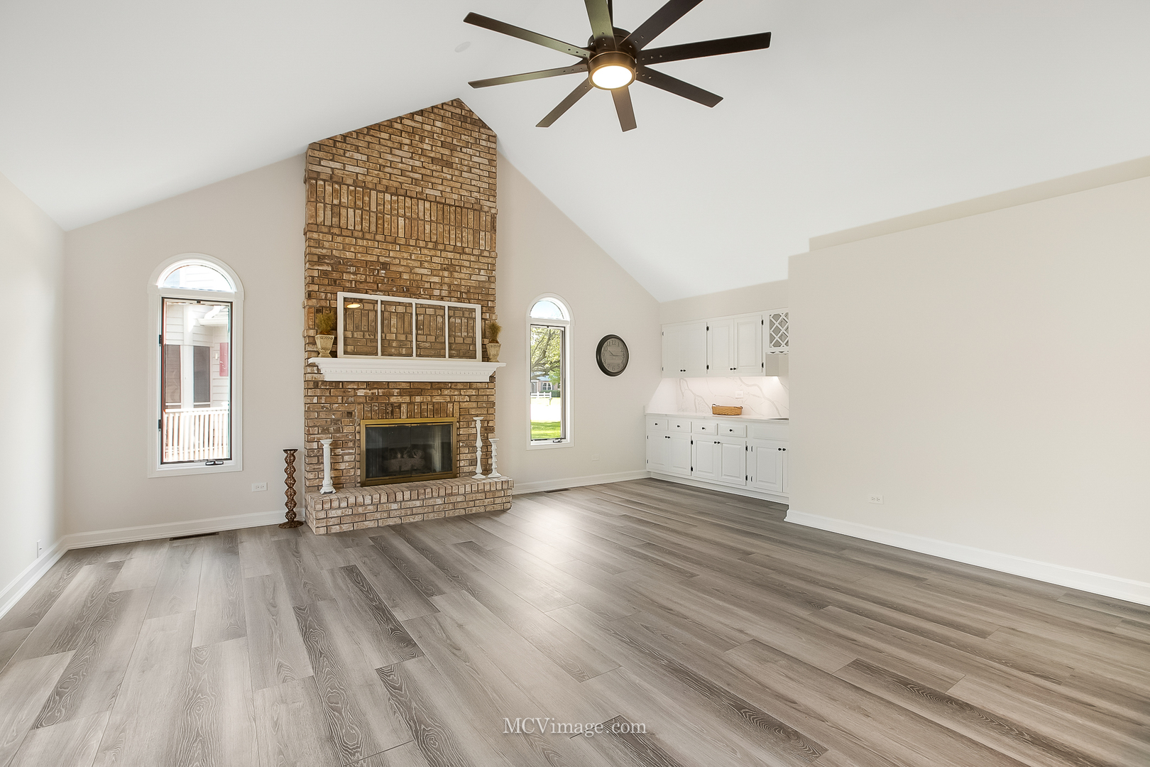 32 Robert Road Oswego, IL 60543 - Photo 9 of 33 a view of empty room with wooden floor and fireplace