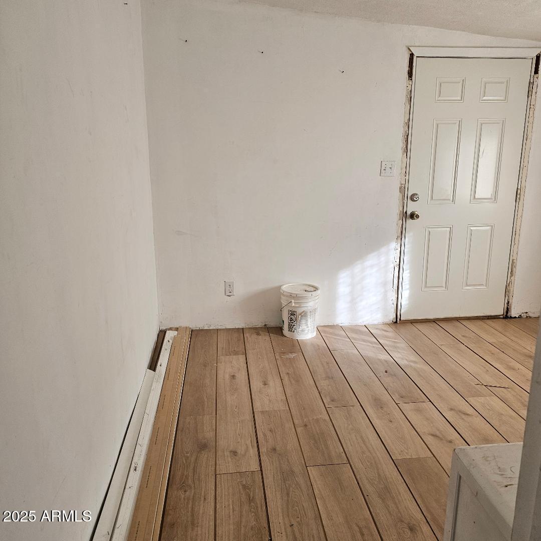 22855 Sunset Lane Congress, AZ 85332 - Photo 30 of 39 a view of a room with wooden floor and white walls