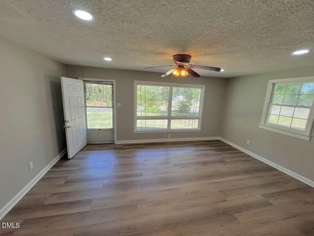 185 Summerhill Road Turkey, NC 28393 - Photo 7 of 18 an empty room with wooden floor and windows