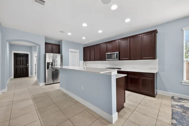 a kitchen with stainless steel appliances granite countertop a sink and cabinets