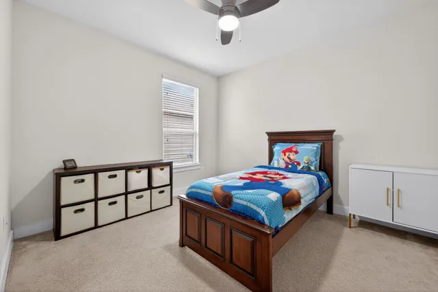a bedroom with a bed and a chandelier
