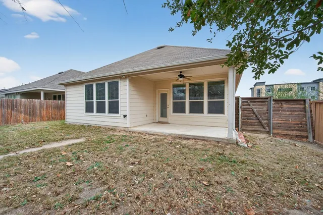 a backyard with hardwood wall and wooden fence