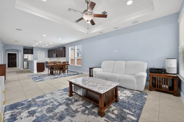a living room with furniture and kitchen view